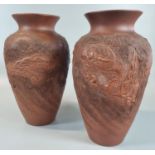 Pair of early 20th century Japanese red clay baluster shaped ceramic vases decorated in relief