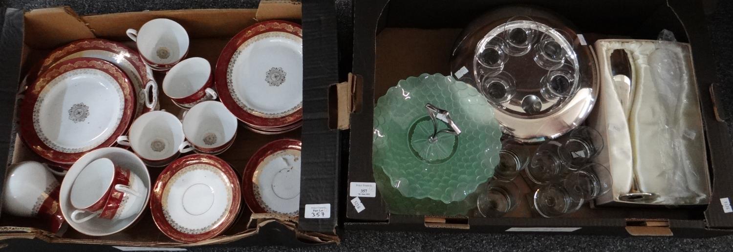 Box of burgundy and gilt German porcelain tea and dinnerware to include: various plates, teacups,