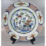 18th century Delft tin glazed earthenware plate hand painted with flowers and foliage. 33cm diameter