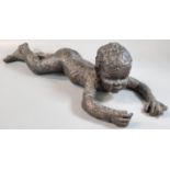 Modern bronzed sculpture of a nude child lying down. 48cm long approx. (B.P. 21% + VAT)