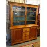 Late Victorian pine two stage cabinet backed bookcase, the moulded cornice above two glazed doors,