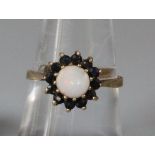 9ct gold opal and red stone dress ring. 2g approx. Size M. (B.P. 21% + VAT)