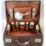 Early 20th century leather cased silver gentleman's travelling vanity set to include: hand mirror,