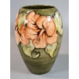 Moorcroft pottery tube lined Hibiscus vase of ovoid form, impressed and signed marks to the