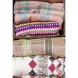 Two boxes of textiles to include: three vintage woollen blankets or carthen with check design, a