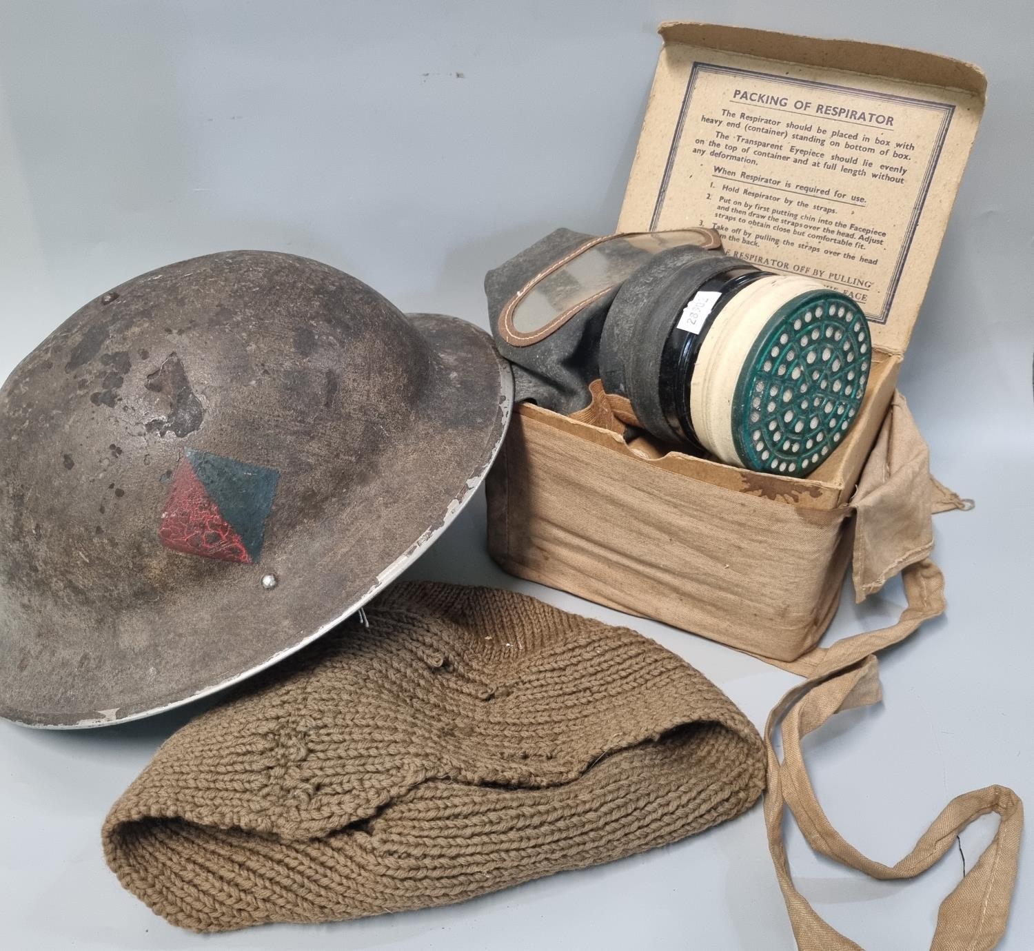 WWII helmet dated 1938/9? together with a boxed gas mask. (2) (B.P. 21% + VAT)