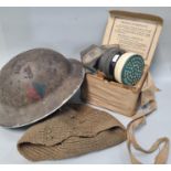WWII helmet dated 1938/9? together with a boxed gas mask. (2) (B.P. 21% + VAT)