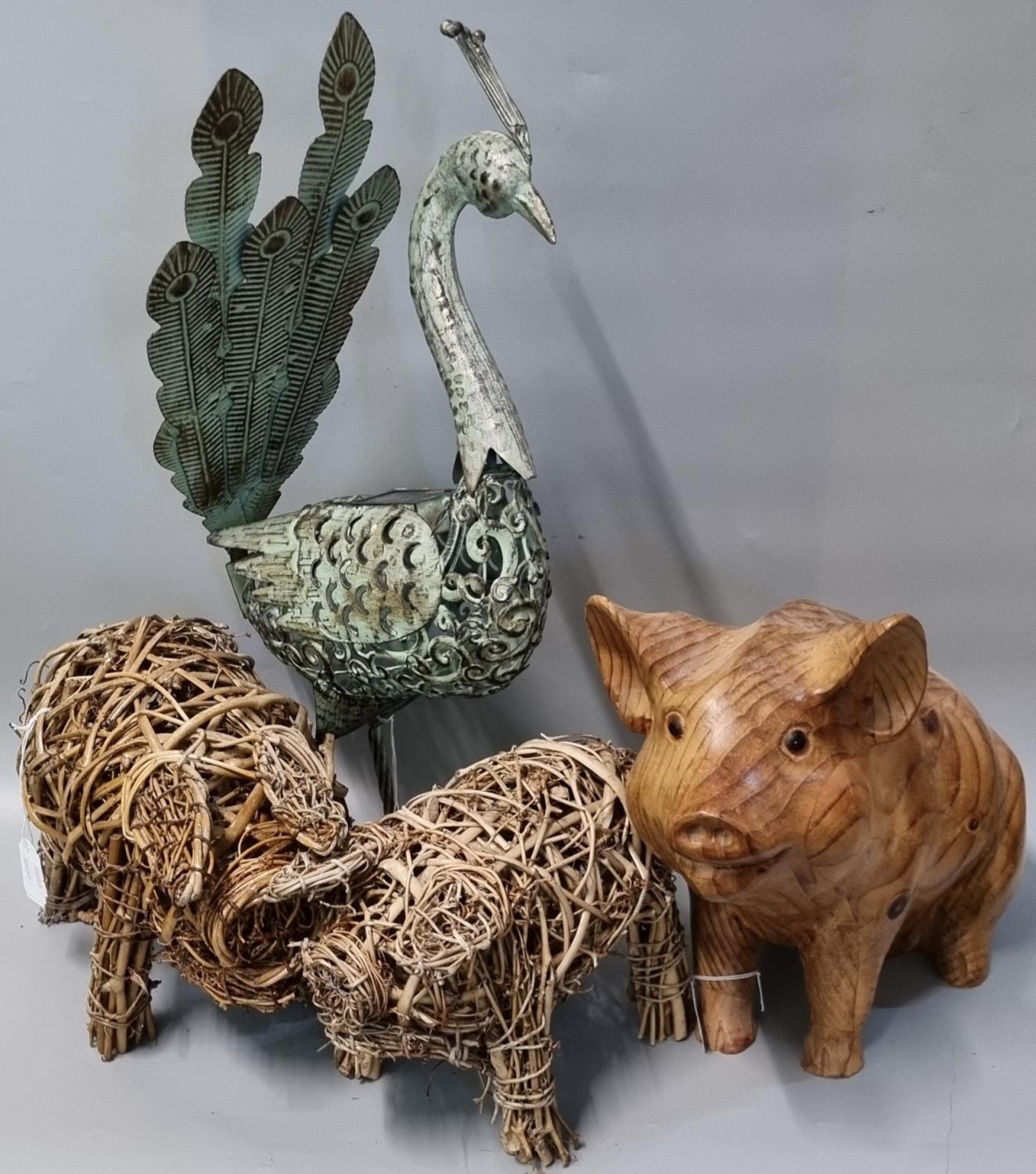 Two wicker models of pigs together with another carved wooden seated pig with glass eyes and a metal
