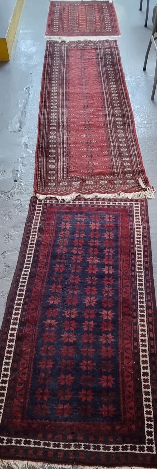 Three Middle Eastern red ground geometric, floral and foliate red ground runners. (3) (B.P. 21% + - Image 2 of 2