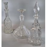 Three cut glass decanters and stoppers, of bell and ship's form. (3) (B.P. 21% + VAT)