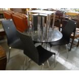 Modern probably marble top circular kitchen table together with four wicker finish chairs, all on