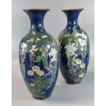 Pair of early 20th century Japanese dark blue ground baluster shaped vases overall decorated with