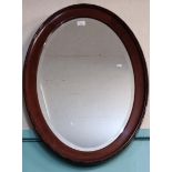 Mahogany framed oval bevelled mirror. (B.P. 21% + VAT)