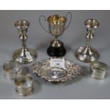 Bag of silver to include: three napkin rings, small two handled trophy cup, silver bonbon dish/pin