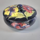 Moorcroft pottery tube lined 'Hisbiscus' circular jar and cover. 14cm diameter approx. Painted and