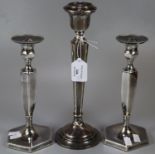 Pair of silver candlesticks with Sheffield hallmarks standing 21cm high approx. with loaded bases