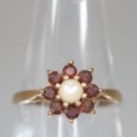 9ct gold pearl and red stone flower head dress ring. Size J. 1.5g approx. (B.P. 21% + VAT)