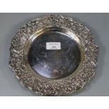 Silver presentation shallow dish repoussé decorated with flowers, fruits and foliage presented to '