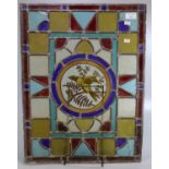 Arts and Crafts design stained and leaded glass panel, the central circular panel decorated with a