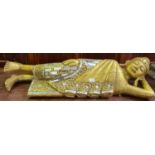 Carved recumbent gilt wood figure of a Thai Buddha, inlaid with mirrored glass. Length 110cm approx.
