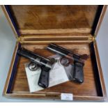 Oak box comprising two Webley Junior .177 pistols. Over 18s Only. (2) (B.P. 21% + VAT)