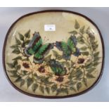 Chelsea pottery, an oval dish on three stylised feet, decorated with butterflies amongst flowers and