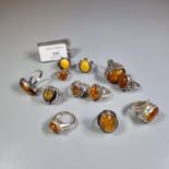 Bag of continental silver and amber dress rings. (B.P. 21% + VAT)