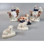 Collection of Staffordshire pottery figures and animals to include: mirror matched pair of seated