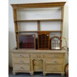 19th century pine rack back dresser, the open rack above a moulded top with an arrangement of