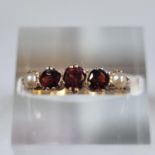 9ct gold pearl and red stone dress ring. 2.1g approx. Size L1/2. (B.P. 21% + VAT)
