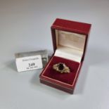 9ct gold and red stone facetted design dress ring. 5.4g approx. Size T. (B.P. 21% + VAT)