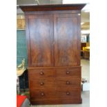 19th century mahogany linen press cupboard, the moulded cornice above two blind panelled doors,