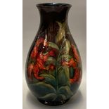 Mid century Moorcroft pottery tube lined 'Hibiscus' vase, on a green graduated ground, of baluster