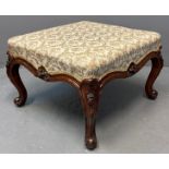 Victorian walnut florally and foliate upholstered footstool, the frame with carved relief flower