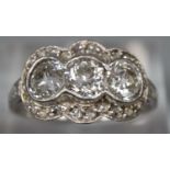 White gold Art Deco triple cluster diamond ring, appearing unmarked. Size M1/2. 3.3g approx. (B.P.