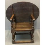 17th century style oak Monk's seat, the oval moulded top above shaped arms, solid seat on baluster