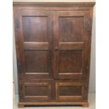 18th century Oak vestment cupboard, the moulded cornice above two blind panelled doors, the interior