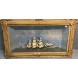 Large 19th century cased ship diorama featuring a British three masted schooner under full sail, the
