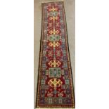 Fine woven multi-coloured ground Caucasian runner with geometric repeating designs. 324 x 73cm