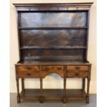 Early 19th century oak dresser, the moulded cornice above plywood back with two fitted shelves,