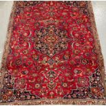 Red ground Persian Mashad floral and foliate carpet. 274 x 192cm approx. (B.P. 21% + VAT)