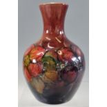 Moorcroft pottery tube lined 'Flambe' Orchid vase of baluster form, impressed marks to the