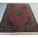 Rich red ground full pile Iranian carpet of Persian Kashan design. (B.P. 21% + VAT)