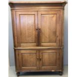 18th century Welsh oak two stage corner cupboard, the moulded cornice above two blind panelled