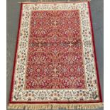 Red ground full pile floral and foliate Kashmir rug. 170 x 120cm approx. (B.P. 21% + VAT)