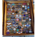 A good glazed case containing various and assorted mainly British motor vehicle enamel badges and