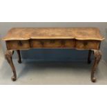 Early 20th century walnut desk in French taste, the shaped moulded top with herringbone inlay