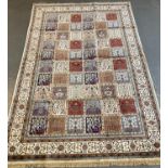 Ivory ground full pile Kashmir carpet with repeating square floral and foliate panels. 306 x 197cm