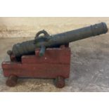 Cast iron, probably French cannon with decorative banding and loop handles over marked 'Gavre Au
