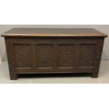 18th century oak coffer, the moulded top with hinged iron mounts above a later ornately carved